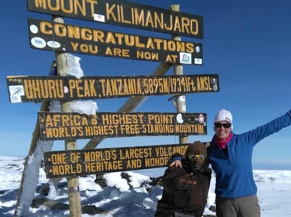 Paula Holt-Rogers, of Eccleston, and one of the guides at the summit of Mount Kilimanjaro, raising funds for Parkinson's UK