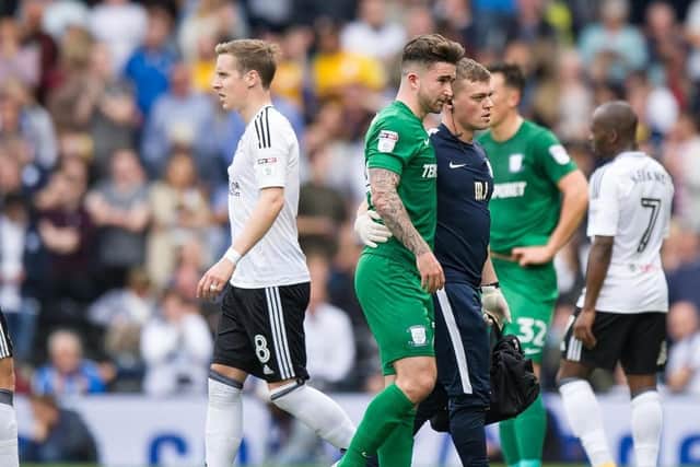 Sean Maguire is helped from the field by physio Matt Jackson at Fulham last season