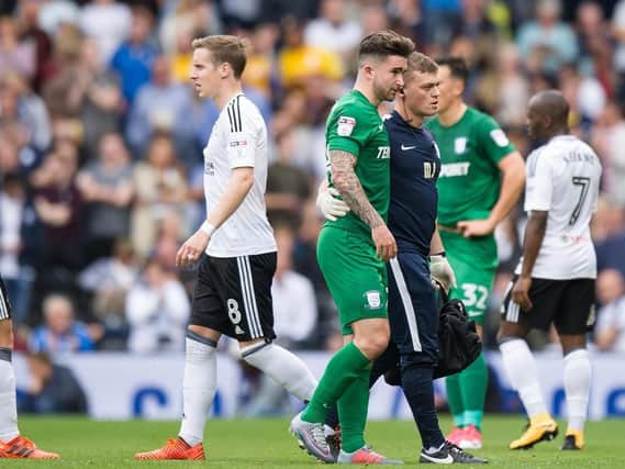 Sean Maguire is helped from the field by physio Matt Jackson at Fulham last season