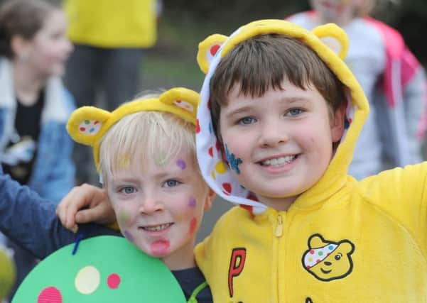 Pudsey the Bear and the BBC Radio Lancashire rickshaw team visit children and staff at Great Eccleston Copp Primary.  Pictured are Charlie Craven and Will Taylor, both aged 7.