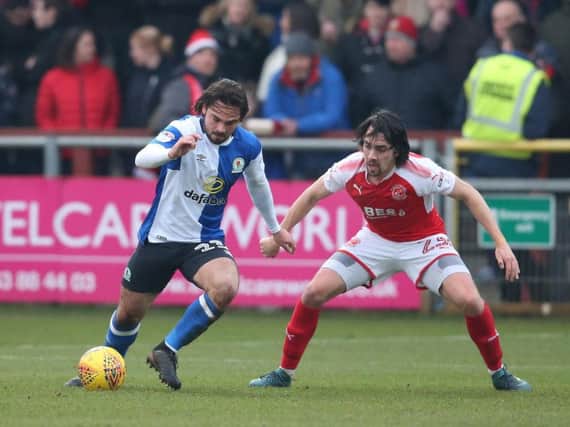 Blackburn Rovers' Bradley Dack shields the ball from Fleetwood Town's Markus Schwabl