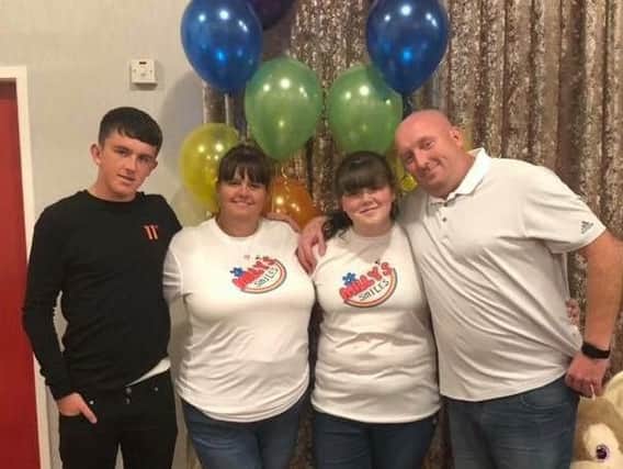 Kirsten Bolton, of Preston, organised a fashion show for Milly's Smiles. She is pictured with her parents and brother, Ben.
