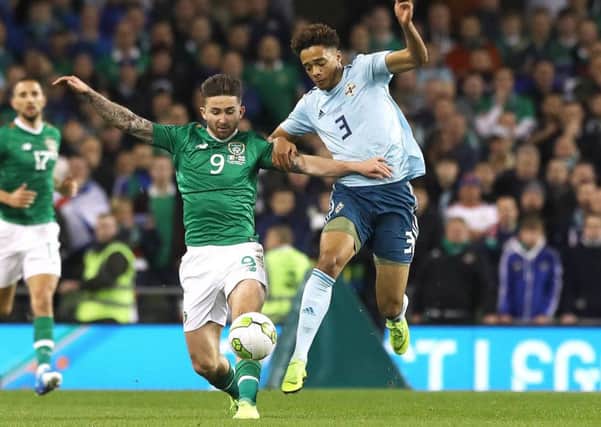 Republic of Ireland's Sean Maguire (left) and Northern Ireland's Jamal Lewis battle for the ball during the International Friendly at The Aviva Stadium, Dublin