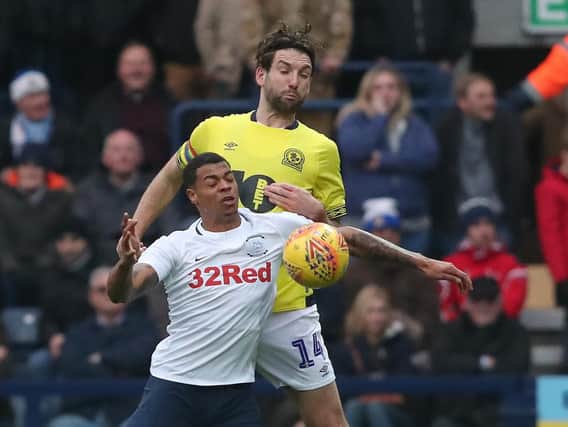 Lukas Nmecha battles with Charlie Mulgrew during the derby at Deepdale on Saturday