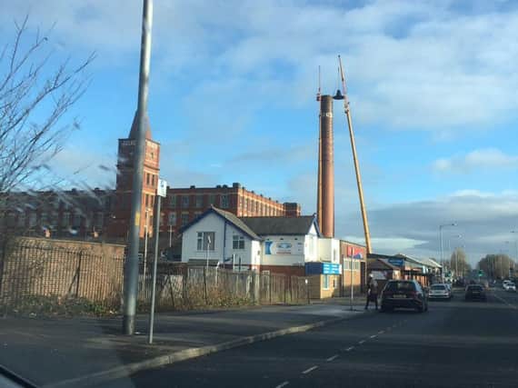 The cranes towering over the Tulketh Mill chimney. Photo: @jennywhitewot