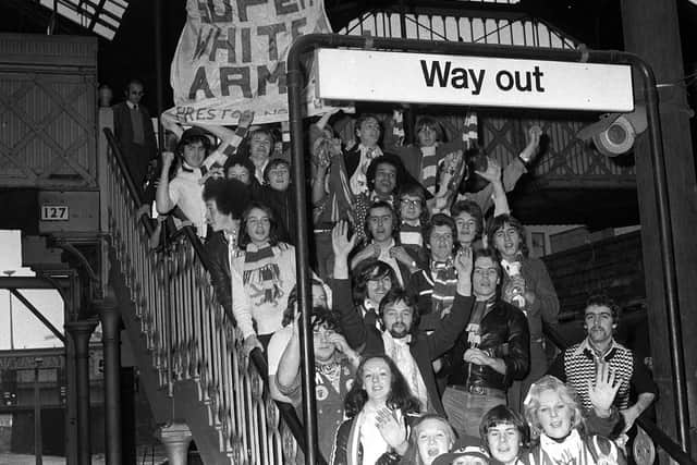 Preston North End fans at Preston railway station prepare to catch a train to Crewe Alexandra for an FA Cup match in 1976