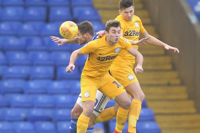 Preston's Ryan Ledson and Jordan Storey challenge in the air against Birmingham