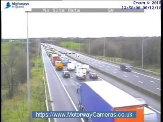 Queuing traffic is waiting to merge on the M6 with only the outside lane open.