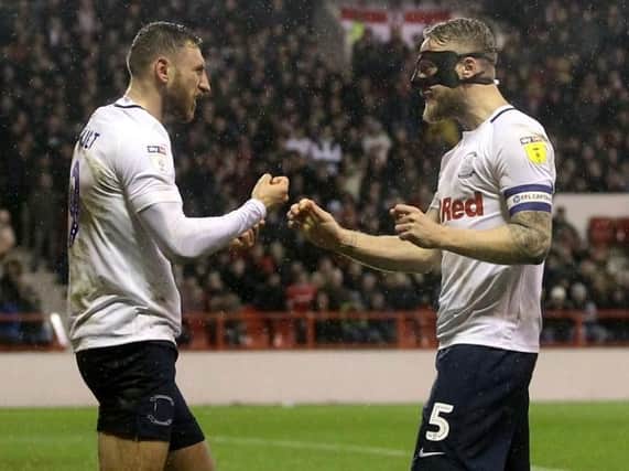 Louis Moult and Tom Clarke celebrate Preston's winner at the City Ground