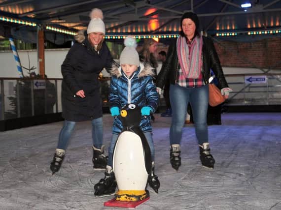 Grace Watson, six, with Tracy Roe and Lisa Moseley on the ice ring at Chorley's Winter Wonderland