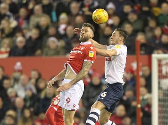 Preston defender Ben Davies challenges in the air with Nottingham Forest striker Daryl Murphy