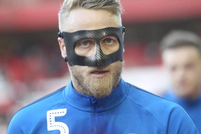 Tom Clarke warms up in his mask ahead of the game against Nottingham Forest