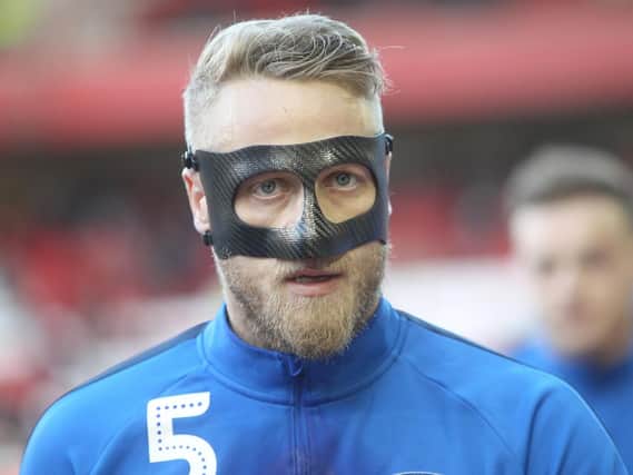Tom Clarke warms up in his mask ahead of the game against Nottingham Forest