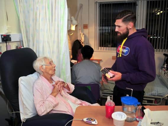 Elizabeth Procter with Jarrod Sammut from Wigan Warriors as they visit the Rosemere Cancer Centre