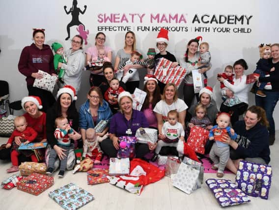 Sweaty Mama exercise class holding Christmas party and donating presents to Derian House