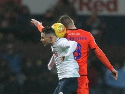 Preston midfielder Alan Browne challenges in the air against Millwall