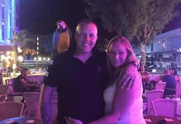 Martin and Lindsey Brown of Chorley posing with a parrot on holiday