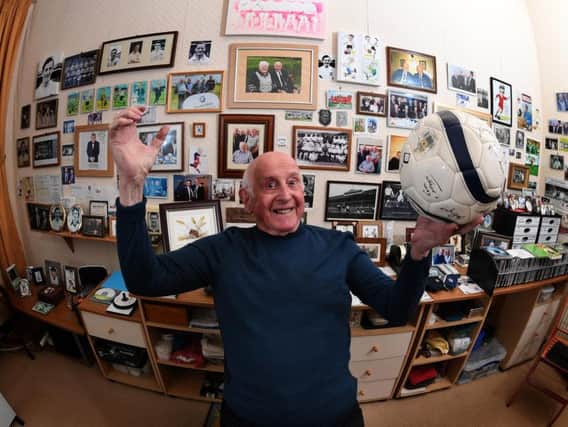 Leo Gornall at home with his collection of football memorabilia