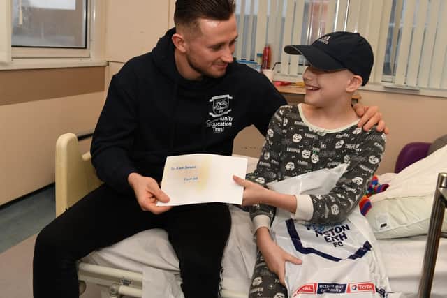 PNE fan Joel Shaw presents a Christmas card to North End midfielder Alan Browne, Picture: Neil Cross