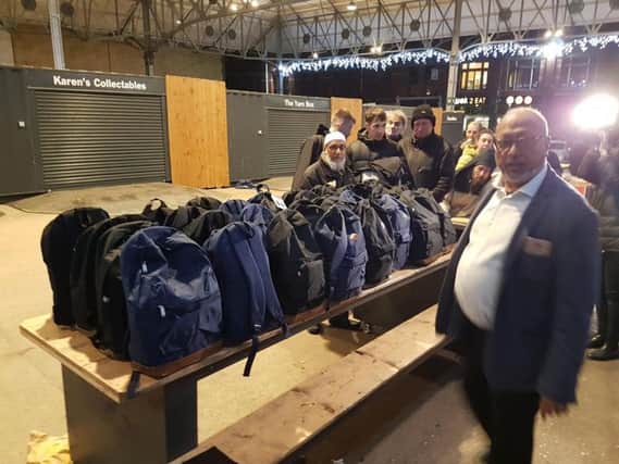 Members of Preston Help the Homeless preparing rucksacks of clothes for the city's homeless