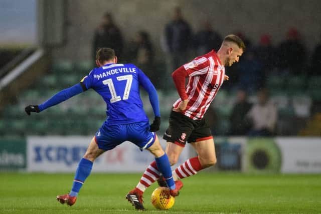 Morecambe's Liam Mandeville battles for possession with Lincoln City's Michael O'Connor during last weekend's League Two clash
