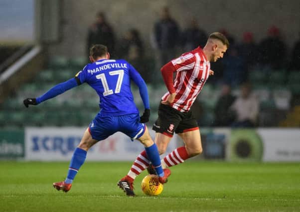 Morecambe's Liam Mandeville battles for possession with Lincoln City's Michael O'Connor during last weekend's League Two clash