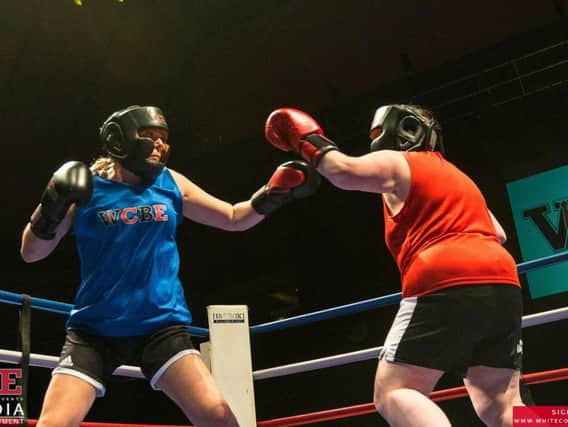 Laura Brookes (in blue) takes part in a boxing match