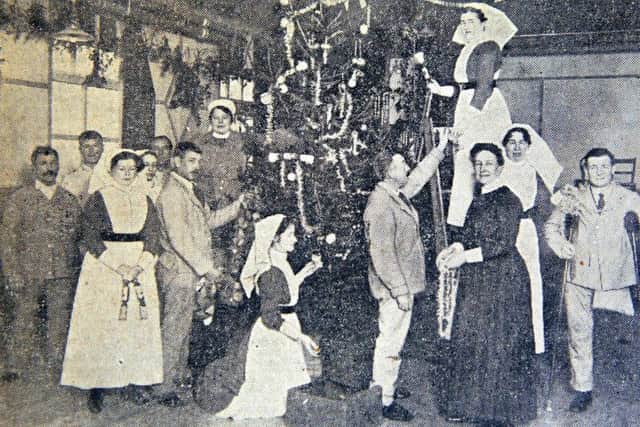 Wounded soldiers at Moor Park Hospital assist in decorating the Christmas Tree