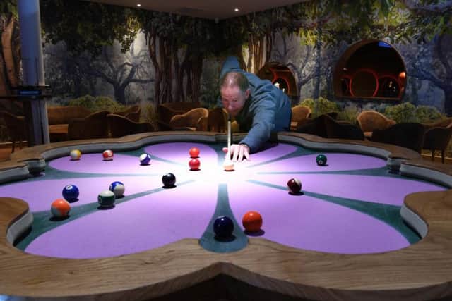 Guy Topping on the custom built flower billiards table