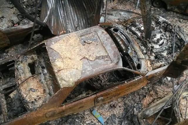 A burnt out car inside the gutted showroom