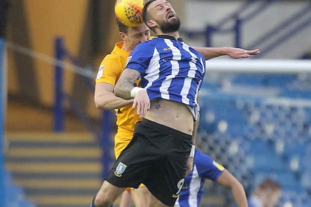 Ben Davies battles with Steven Fletcher at Hillsborough on Saturday