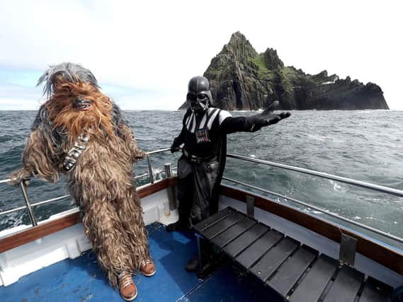 Star Wars fans dressed as Darth Vader (right) and Chewbacca on a boat trip to Skellig Michael