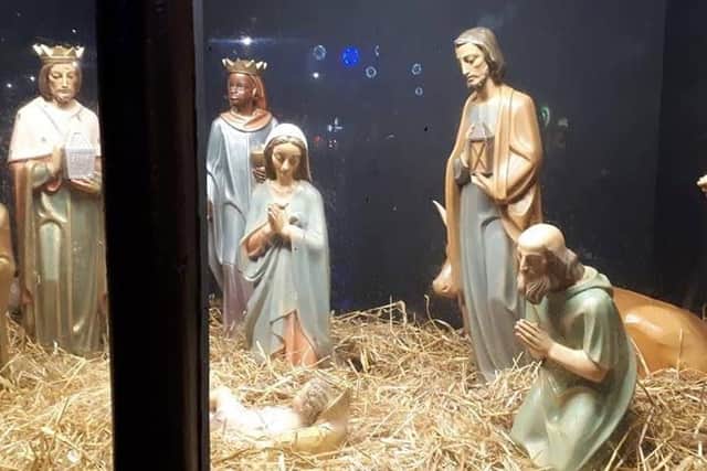 The nativity scene is protected by plastic glass, but vandals had smashed a hole in the display window.
