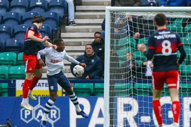 Doncaster striker John Marquis gets above PNE right-back Darnell Fisher to head the visitors into the lead at Deepdale