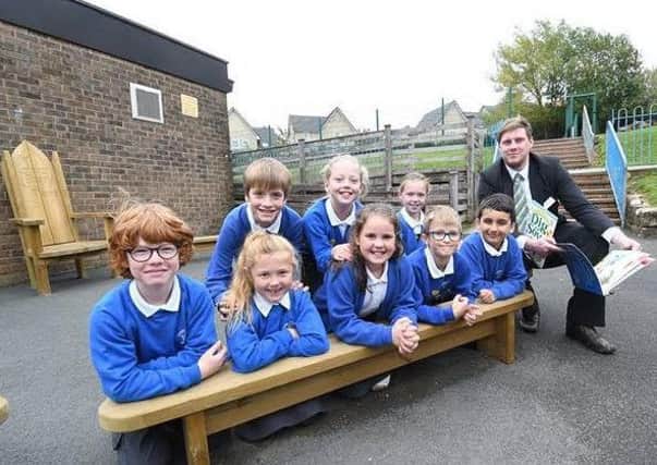 Pupils from Lancaster Christ Church CE Primary School and Sales Adviser Neil Richardson with the storytelling bench