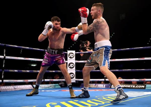 Scott Fitzgerald (left) in action against Craig Morris during their super-welterweight contest at the Birmingham Arena