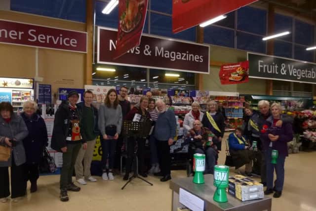 Members of Chorley and District Oxfam Campaigns Group and friends sang at Buckshaw Tesco, raising 329.40 for Oxfam