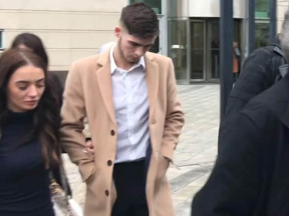 Irish League footballer Jay Donnelly, 23, leaves Belfast Magistrates' Court where he was handed a four-month prison sentence for distributing an indecent image of a child.