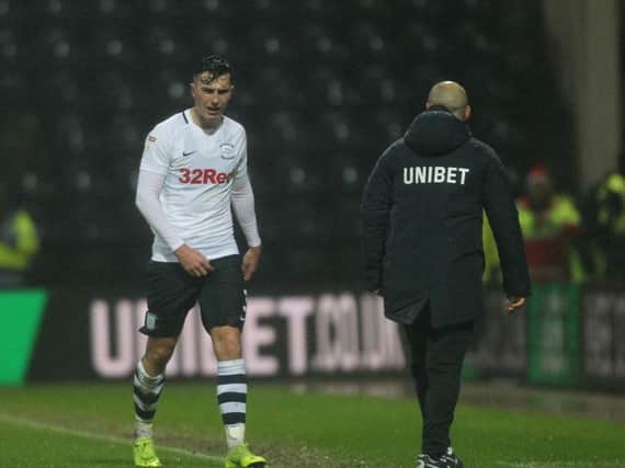 Preston left-back Josh Earl leaves the pitch after being sent-off against Swansea, watched by Alex Neil