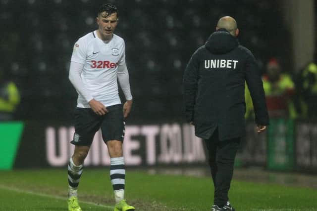 Preston left-back Josh Earl leaves the pitch after being sent-off against Swansea, watched by Alex Neil