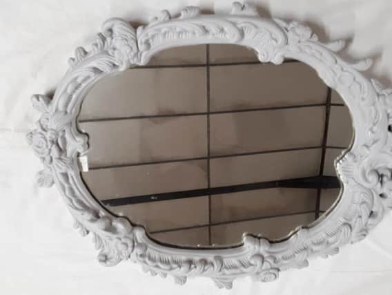 This grey decorative mirror is on sale for 35 pounds