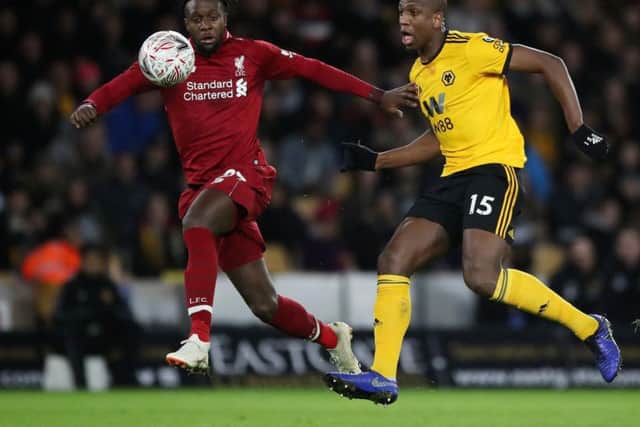 Liverpool's Divock Origi and Wolverhampton Wanderers' Willy Boly battle for the ball