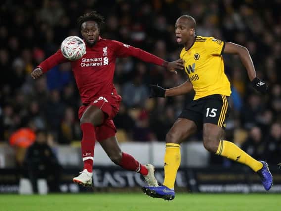Liverpool's Divock Origi and Wolverhampton Wanderers' Willy Boly battle for the ball