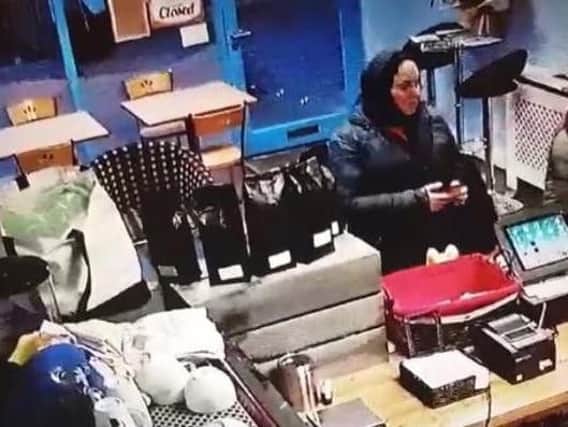 Three women can be seen stealing a charity donations box from the counter of the Lazy Cat Cafe in Cannon Street, Preston on Wednesday, January 16.