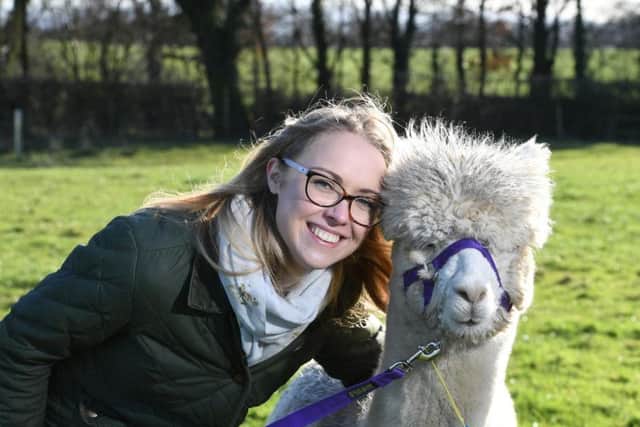 Josie Shahabeddin with one of her alpacas