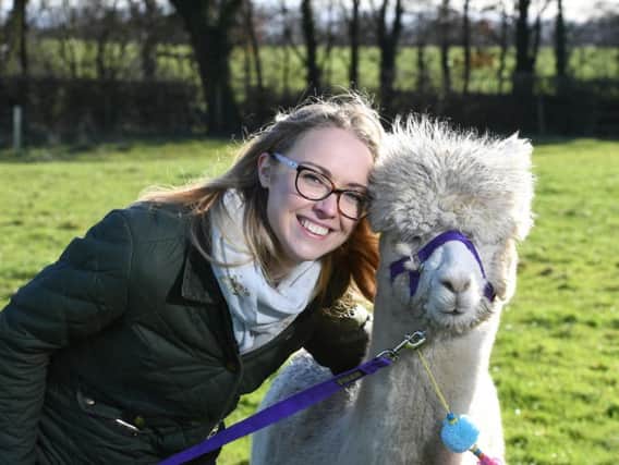 Josie Shahabeddin with one of her alpacas