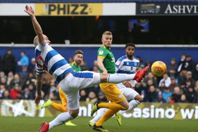 Preston striker Jayden Stockley watches as Toni Leistner clears the ball