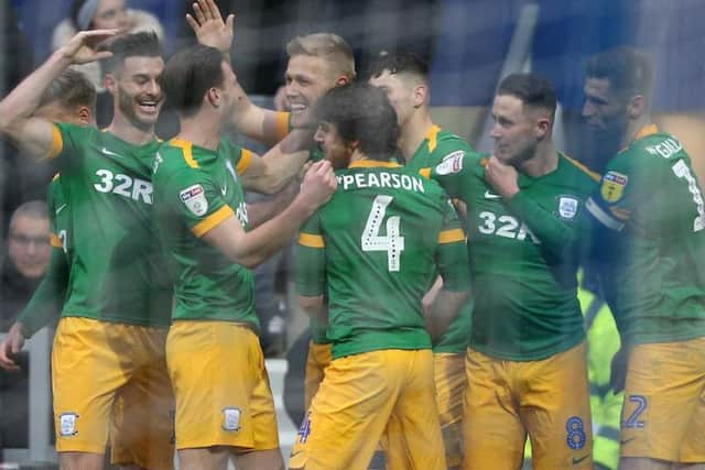 Ben Pearson and the Preston players celebrate Jayden Stockley's opening goal at Loftus Road