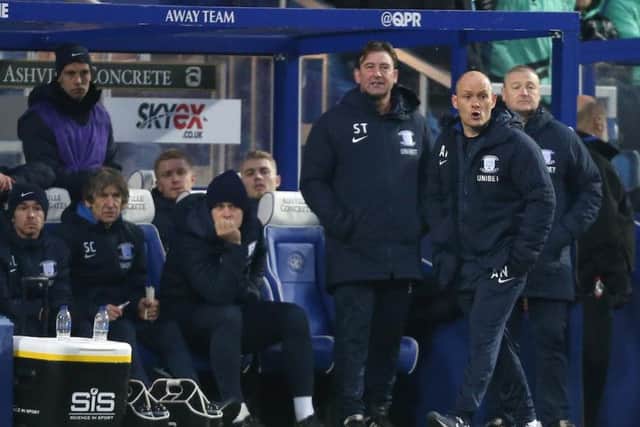 Alex Neil and the PNE bench look on at Loftus Road