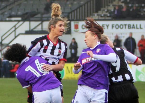 Michelle Saunders rises high to power a head towards the Bolton goal